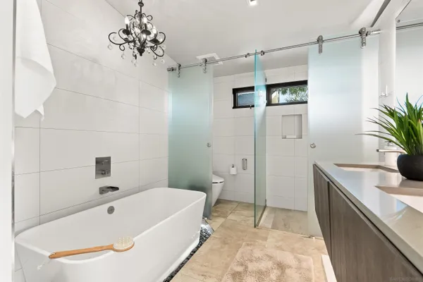 a kitchen with stainless steel appliances granite countertop a sink and a refrigerator