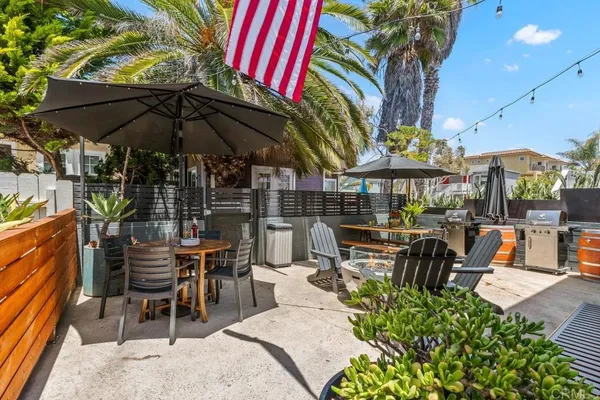 a patio with a table and chairs under an umbrella