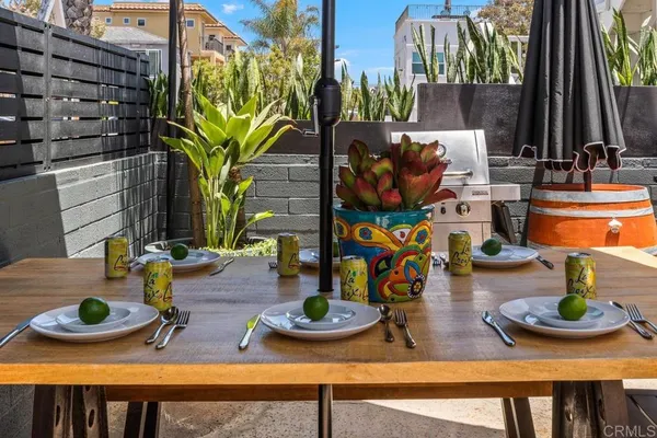 a view of a dining room with furniture and a potted plant