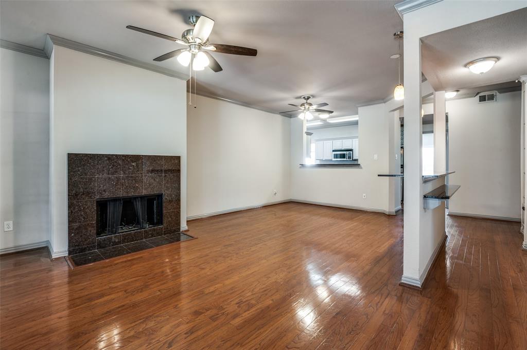 2524 Preston Road, Unit 1404 Plano, TX 75093 - Photo 3 of 15 a view of empty room with wooden floor and a fireplace