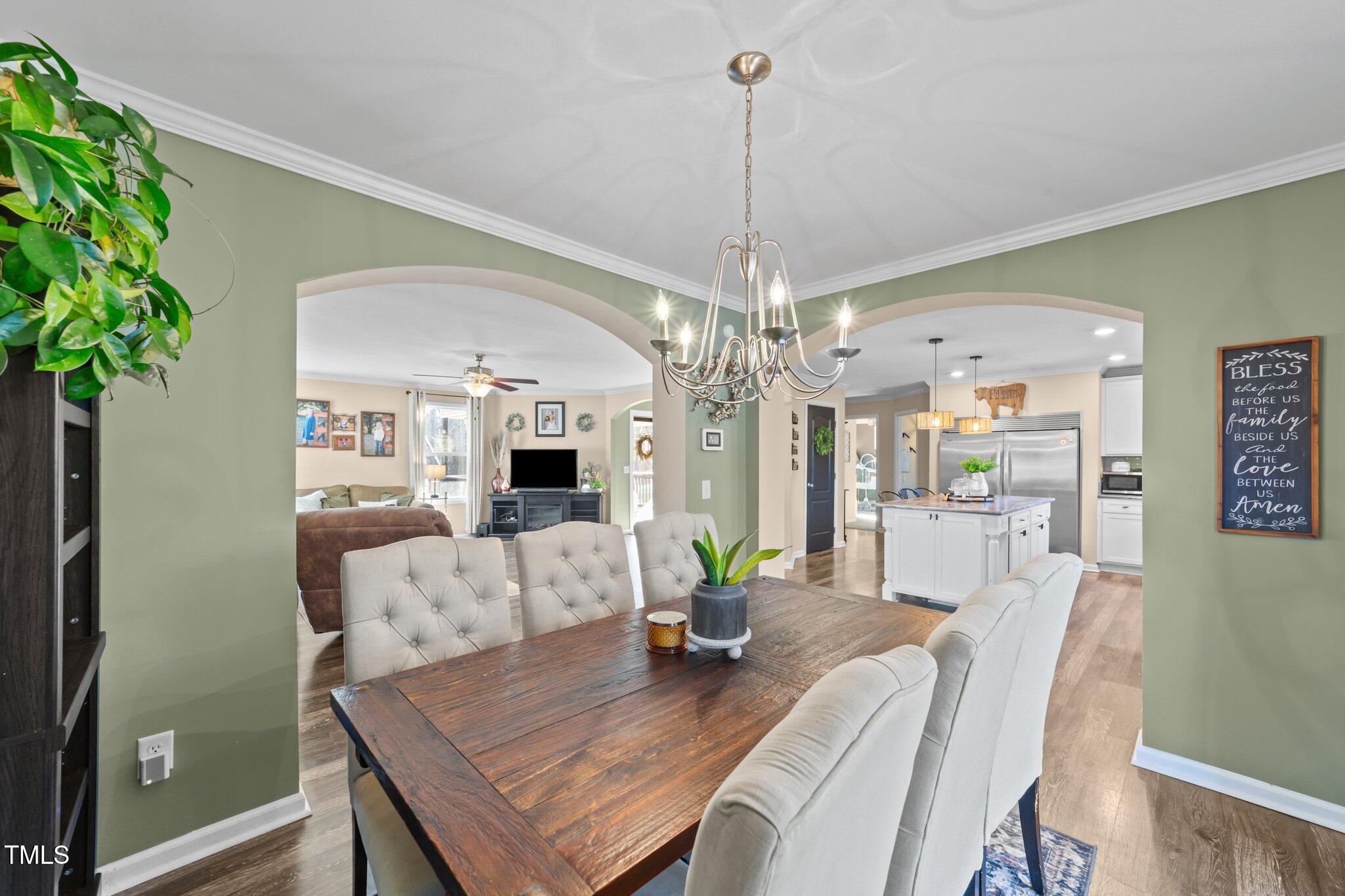 1500 Cheves Road Zebulon, NC 27597 - Photo 10 of 42 a view of a dining room with furniture wooden floor and chandelier