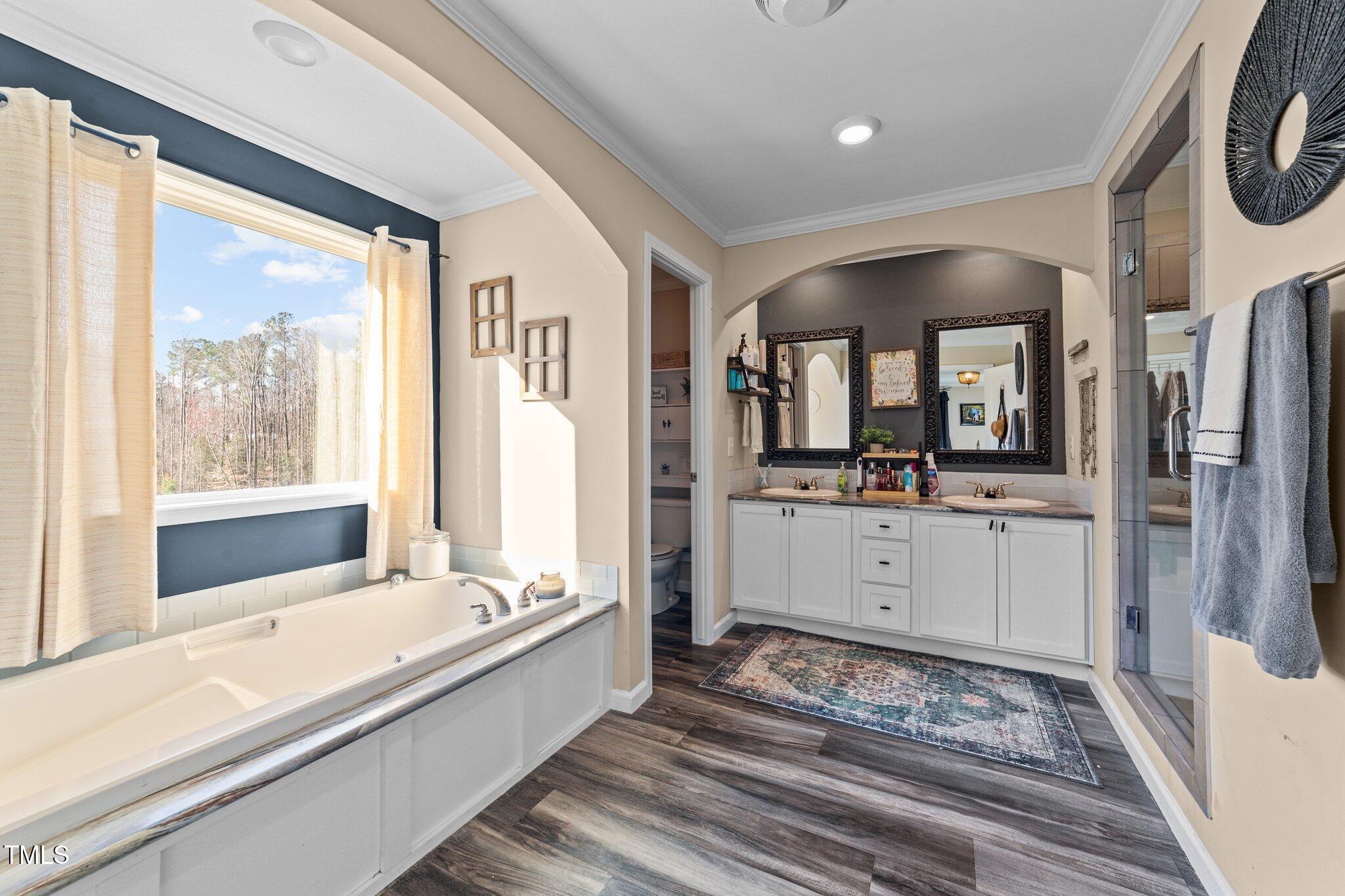 1500 Cheves Road Zebulon, NC 27597 - Photo 21 of 42 a large bathroom with a large tub and sink