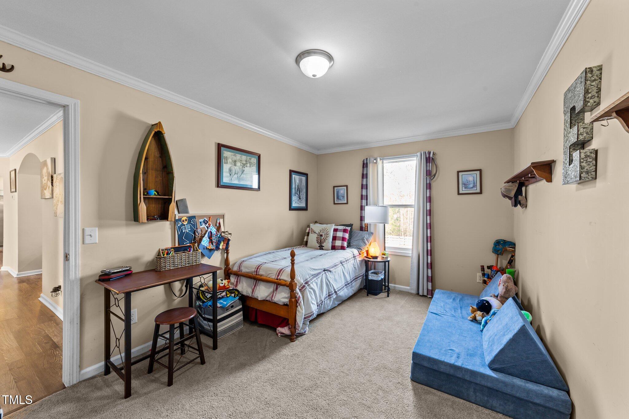 1500 Cheves Road Zebulon, NC 27597 - Photo 26 of 42 a bedroom with furniture and a wooden floor