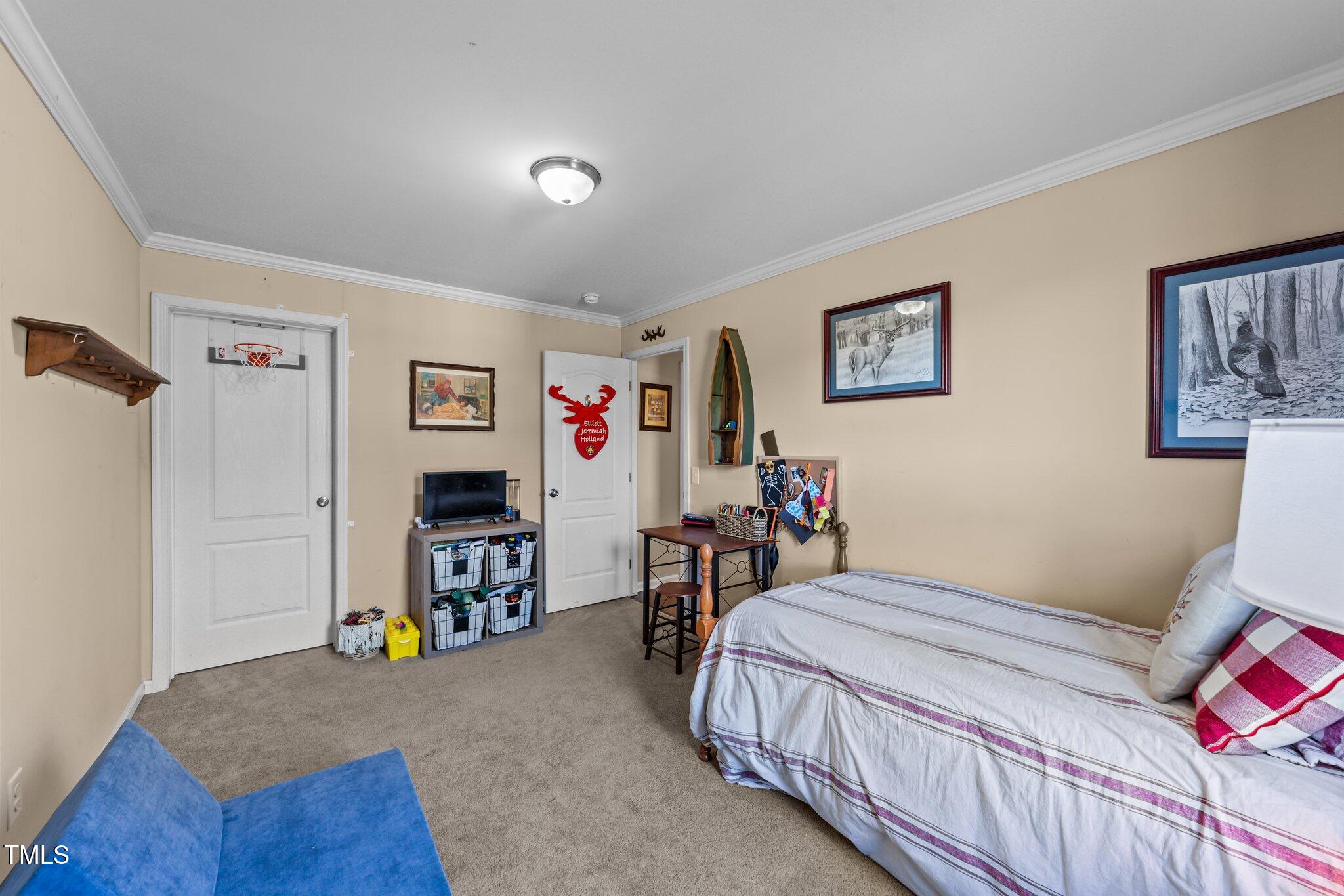 1500 Cheves Road Zebulon, NC 27597 - Photo 27 of 42 a bedroom with a bed and a view of kitchen