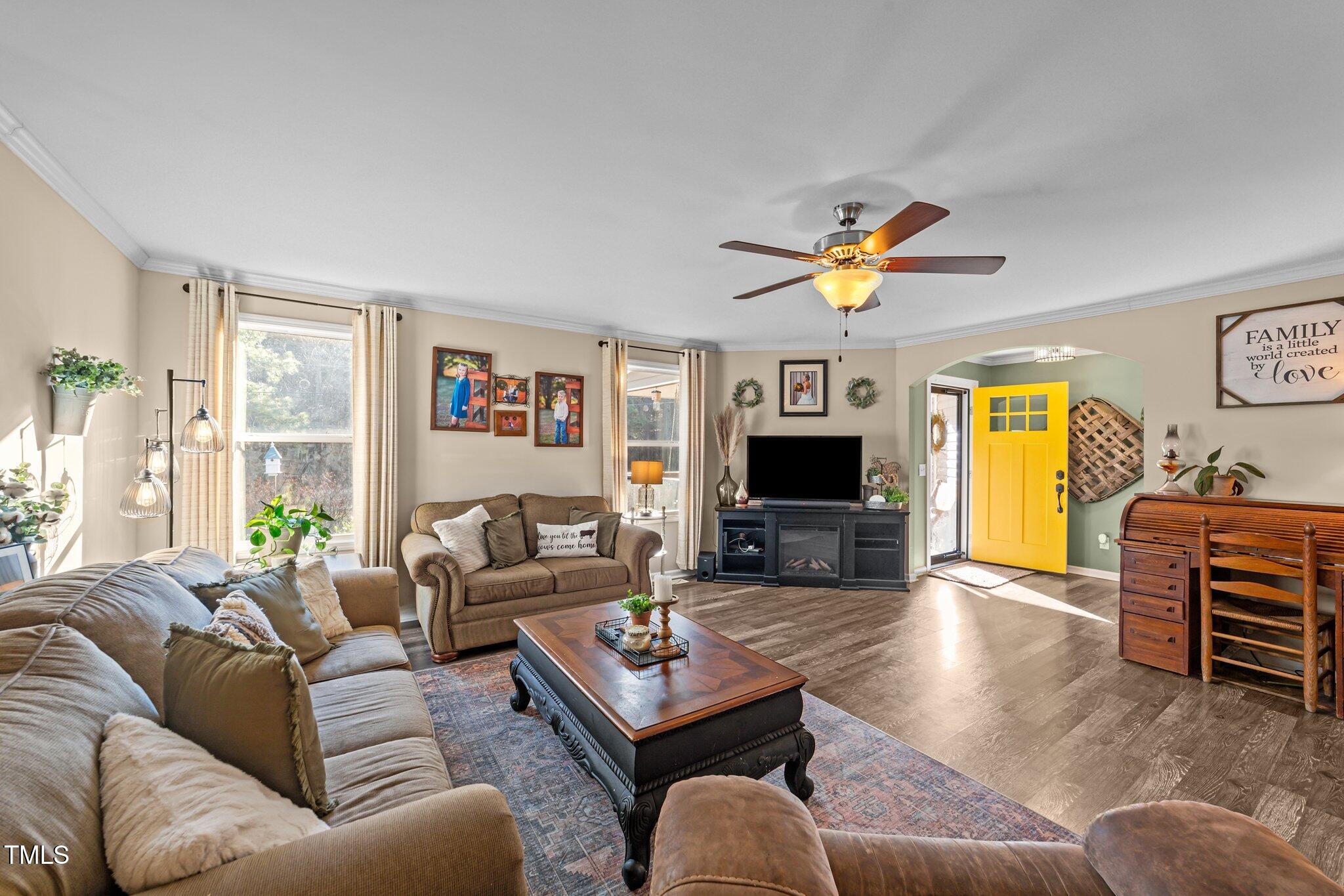 1500 Cheves Road Zebulon, NC 27597 - Photo 6 of 42 a living room with furniture a flat screen tv and a large window