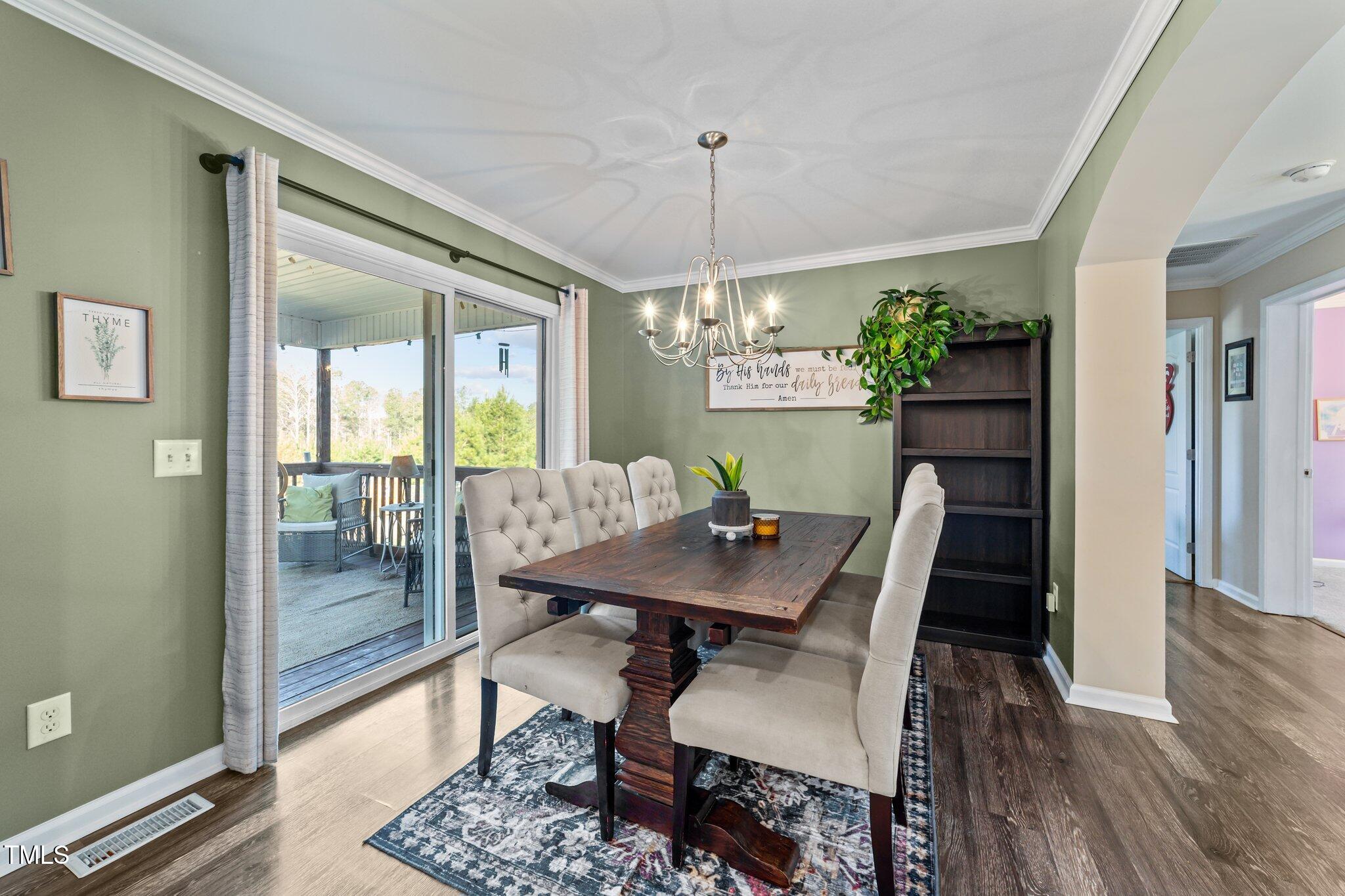 1500 Cheves Road Zebulon, NC 27597 - Photo 8 of 42 a view of a dining room with furniture window and wooden floor