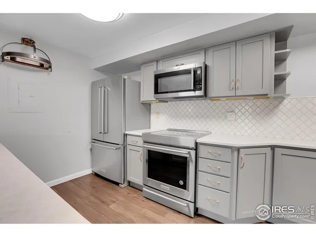 a kitchen with stainless steel appliances granite countertop a stove microwave and sink