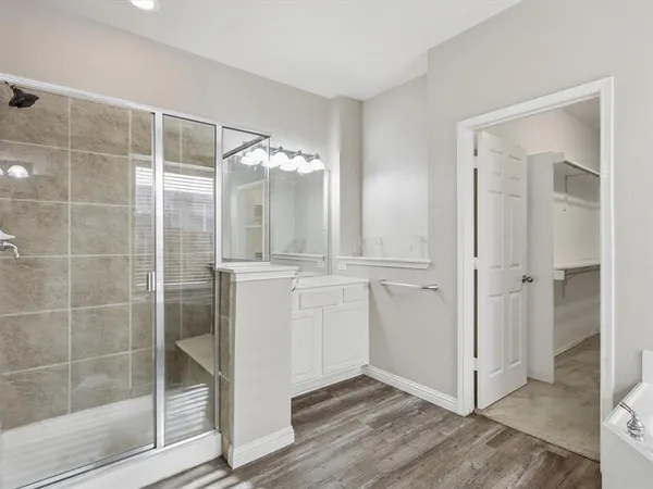 a bathroom with a shower and a mirror