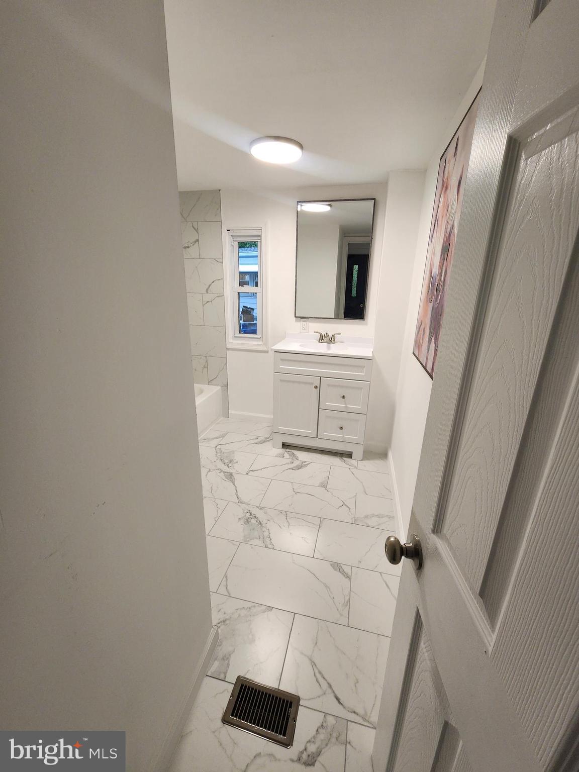 126 Country Lane Buena, NJ 08310 - Photo 12 of 12 a bathroom with a sink a mirror and a toilet