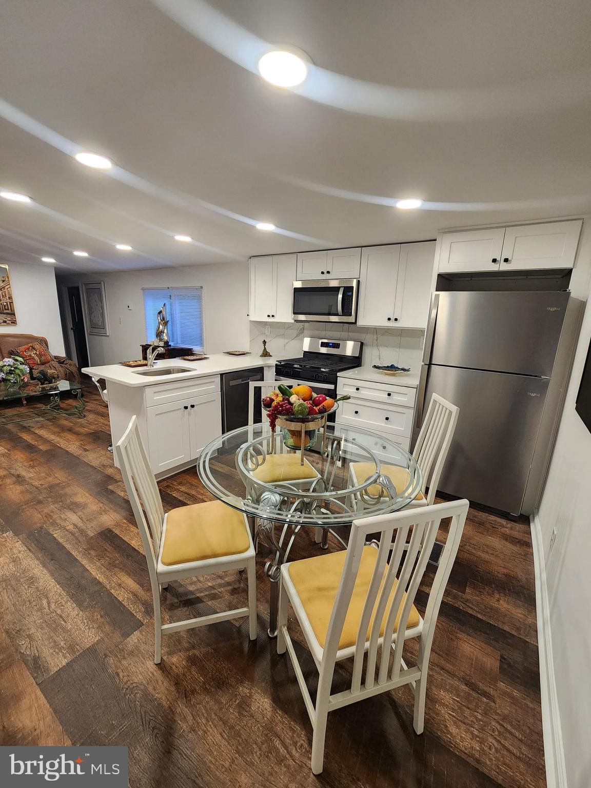 126 Country Lane Buena, NJ 08310 - Photo 6 of 12 a kitchen with stainless steel appliances a stove a refrigerator and a dining table