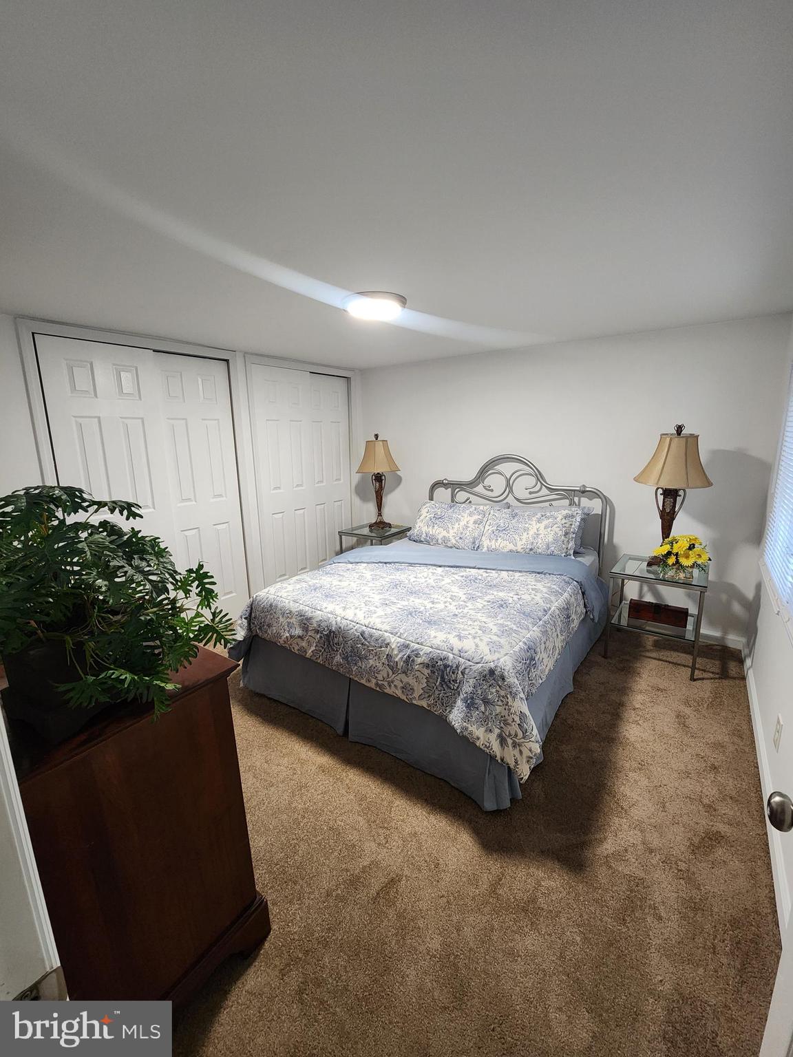 126 Country Lane Buena, NJ 08310 - Photo 9 of 12 a bedroom with a bed and a potted plant