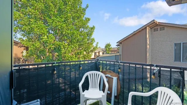 a view of balcony with two chairs and a table