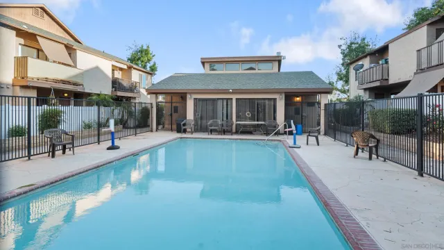a view of a patio with swimming pool table and chairs
