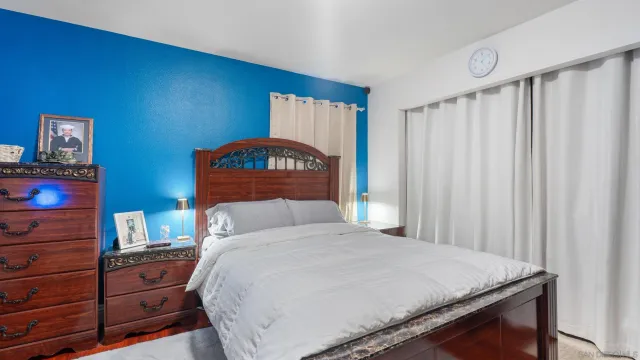 a bedroom with a bed and a dresser