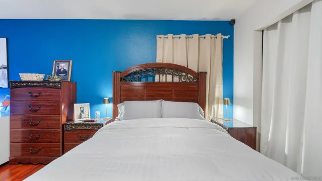 a bedroom with a bed and a dresser