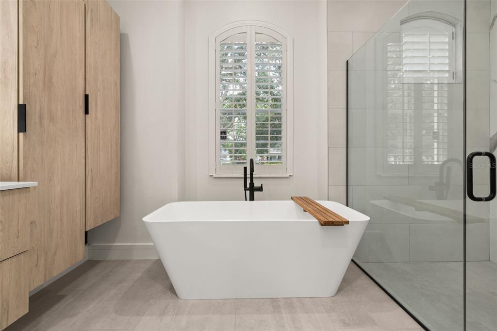 8351 Bowden Way Windermere, FL 34786 - Photo 24 of 71 a white bath tub sitting in a bathroom next to a window