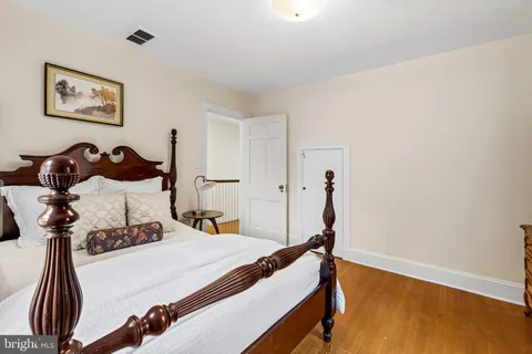 a bed room with a bed and a painting on the wall