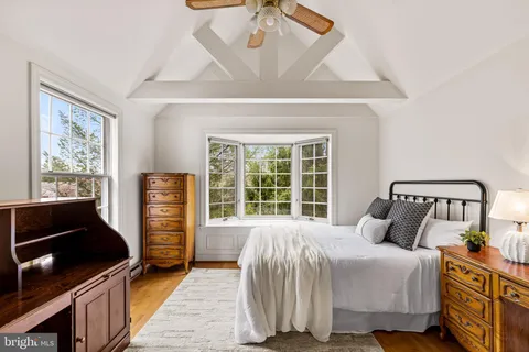 a bedroom with a bed and a large window