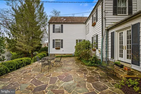 a view of a backyard with table and chairs and potted plants