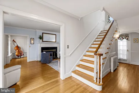 a view of a livingroom with wooden floor and stairs