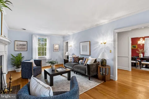 a living room with furniture or wooden floor and a large window