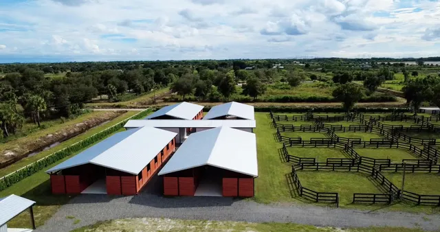 an aerial view of a house with a yard basket ball court and outdoor seating