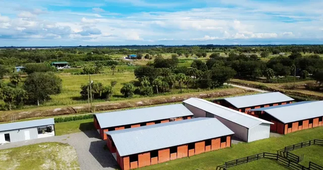 an aerial view of a house with a big yard