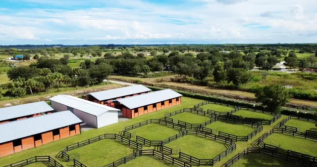 an aerial view of a house with swimming pool having outdoor seating