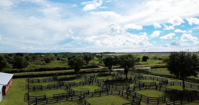 a view of swimming pool with seating area and green space