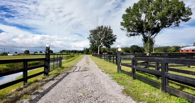 a view of park with wooden floor and fence