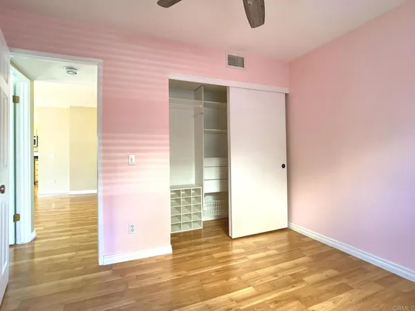 a view of an empty room with wooden floor