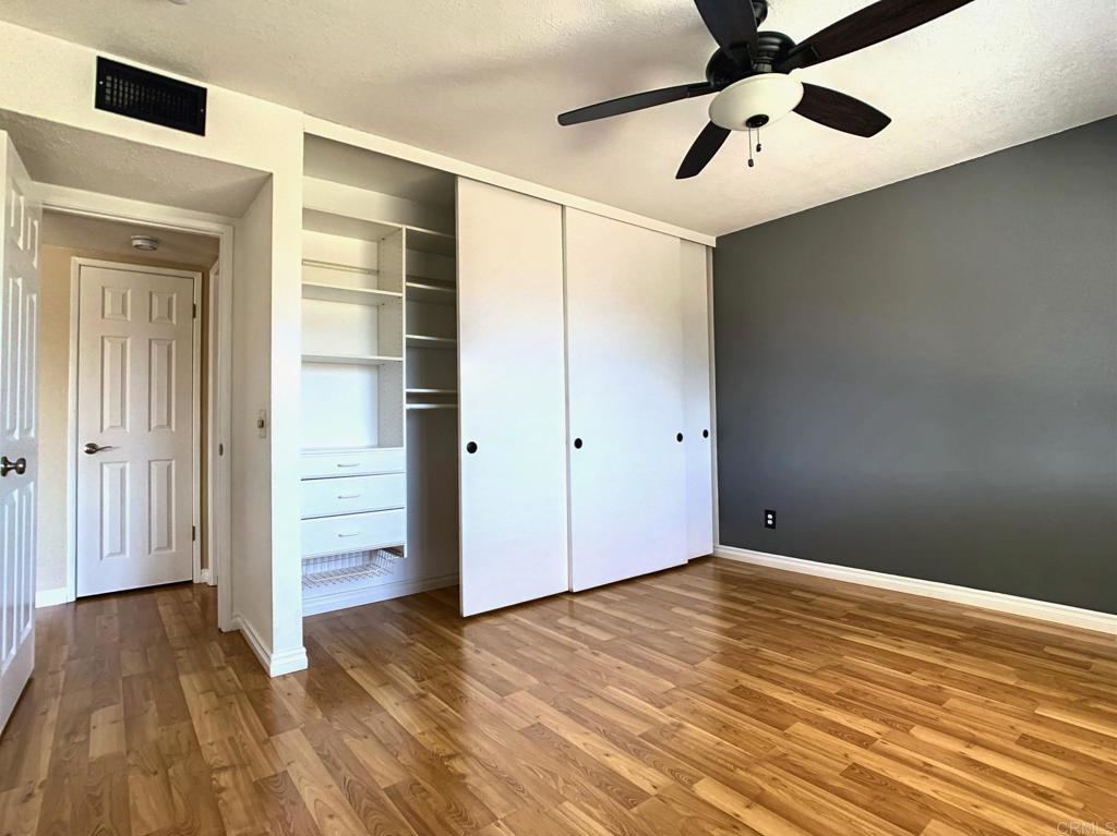 3331 Eton Greens Court Spring Valley, CA 91978 - Photo 19 of 39 an empty room with wooden floor closet and windows