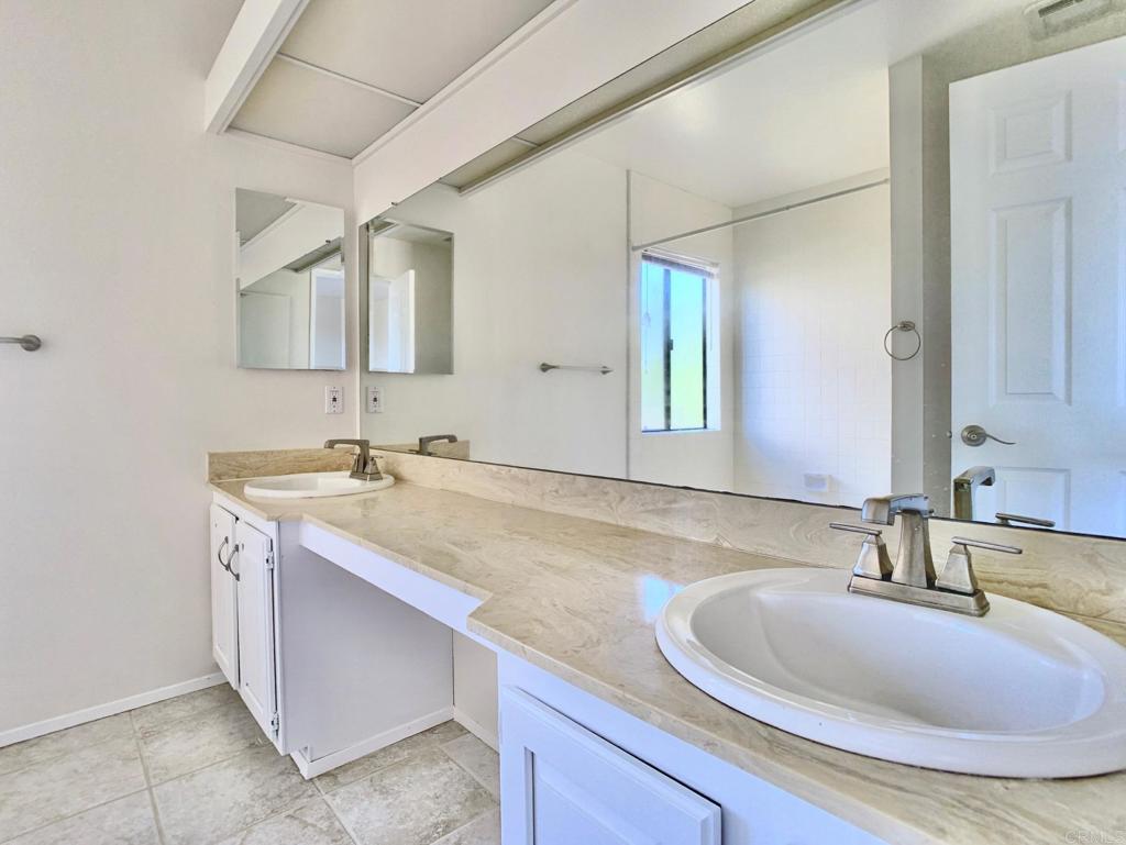 3331 Eton Greens Court Spring Valley, CA 91978 - Photo 24 of 39 a bathroom with a granite countertop sink and a mirror