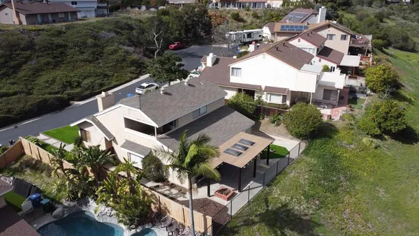 an aerial view of a house with a yard