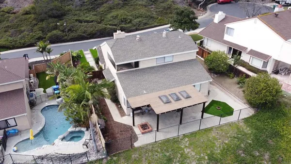 an aerial view of a house with a yard table and chairs