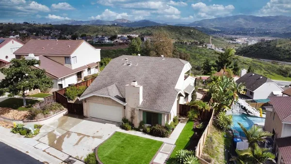 an aerial view of a house with a yard