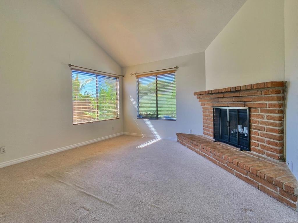 3331 Eton Greens Court Spring Valley, CA 91978 - Photo 8 of 39 an empty room with windows and fireplace