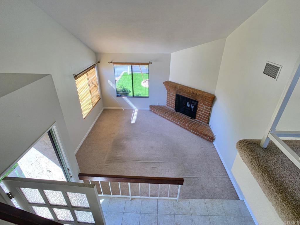 3331 Eton Greens Court Spring Valley, CA 91978 - Photo 10 of 39 a view of a livingroom with wooden floor and a fireplace