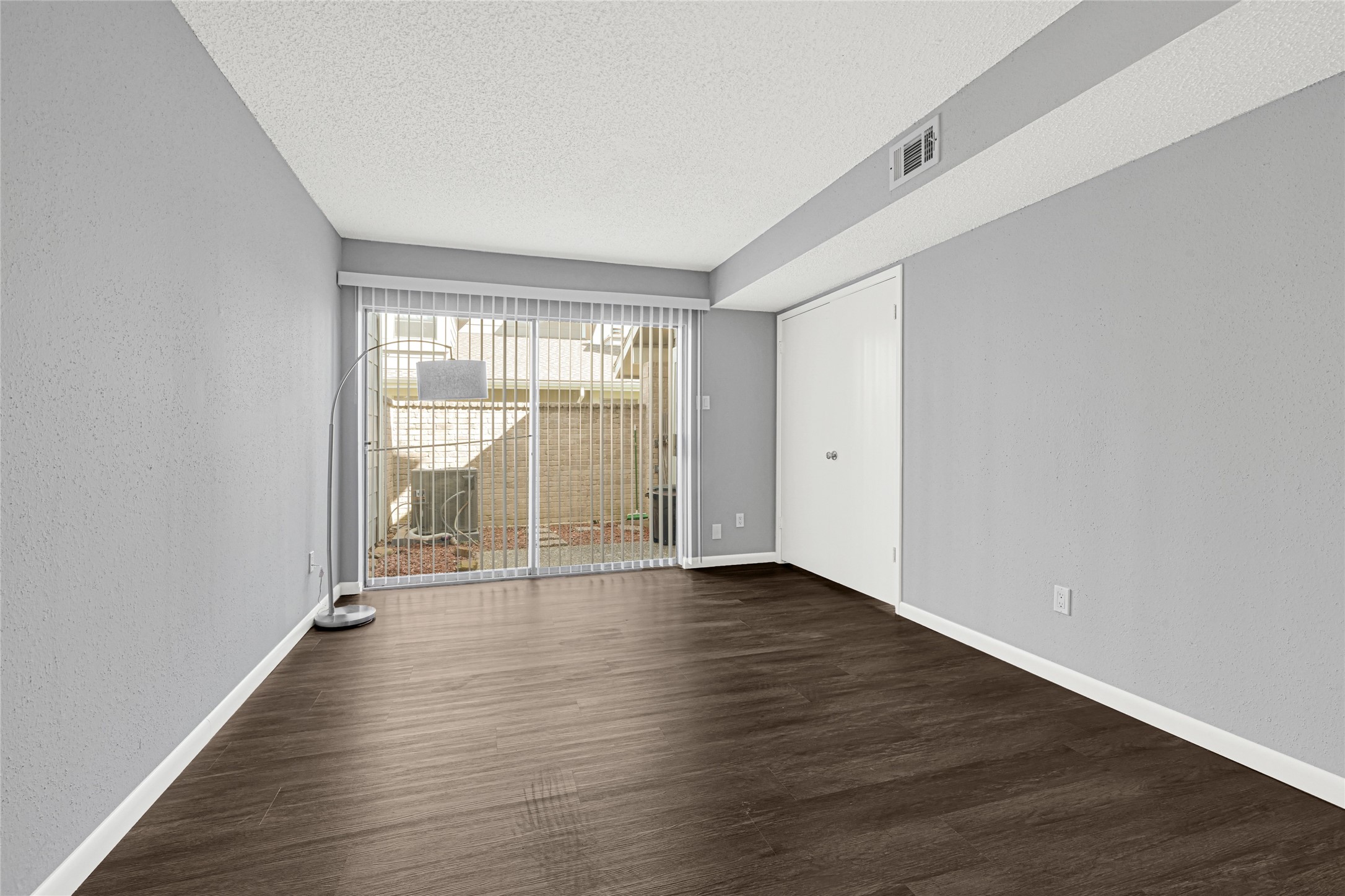 12111 Lemon Ridge Lane, Unit 121 Houston, TX 77035 - Photo 13 of 25 an empty room with wooden floor and windows