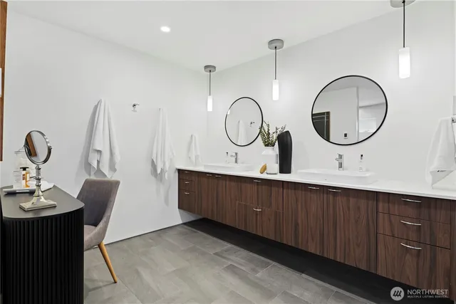 a bathroom with a double vanity sink and a mirror