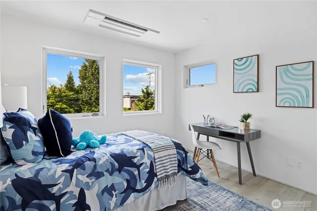 a bedroom that has a bed and a chair in it