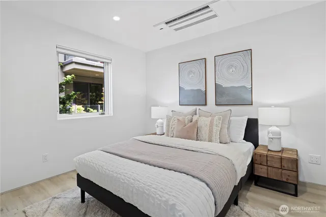 a bedroom with a bed and a painting on the wall