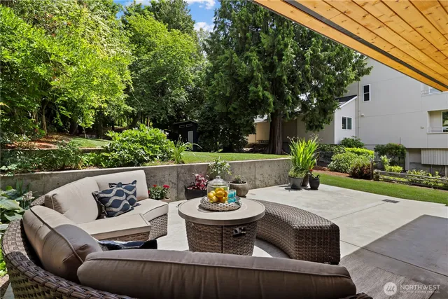 a view of a patio with couches table and chairs and potted plants