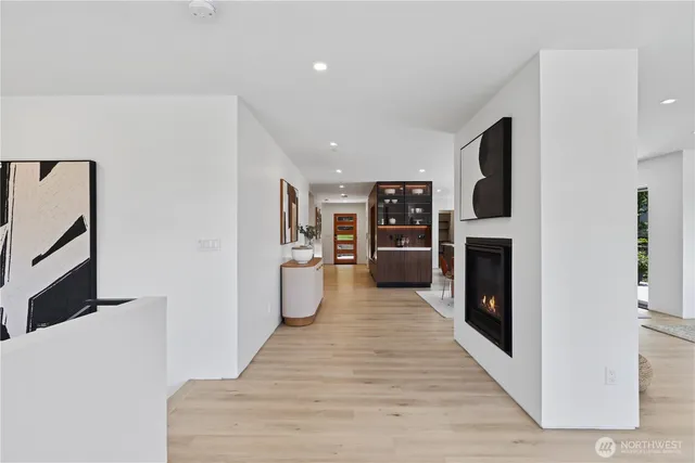 a view of a kitchen with refrigerator and a stove top oven