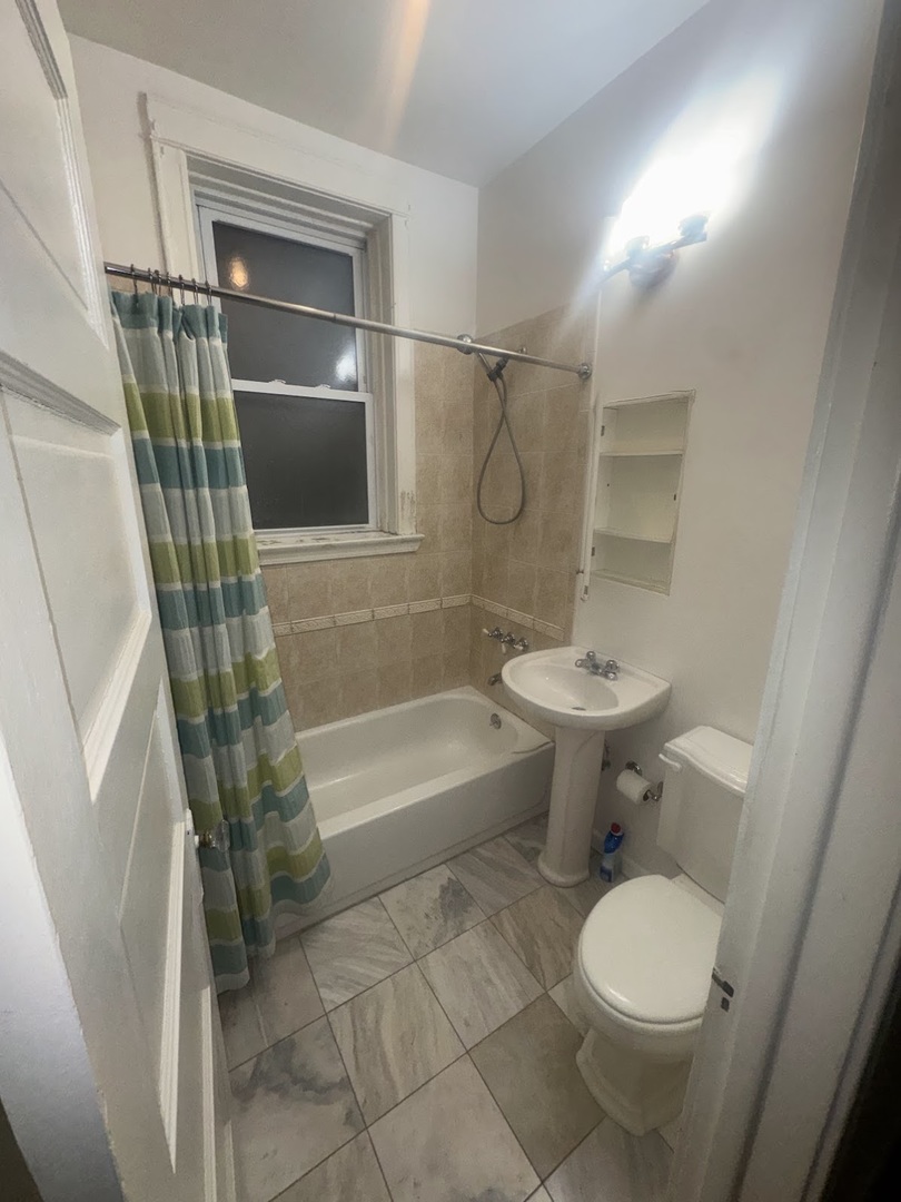 3030 West Belden Avenue Chicago, IL 60647 - Photo 4 of 12 a bathroom with a sink toilet and shower