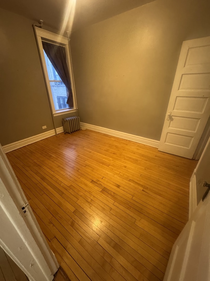 3030 West Belden Avenue Chicago, IL 60647 - Photo 5 of 12 a view of an empty room with wooden floor