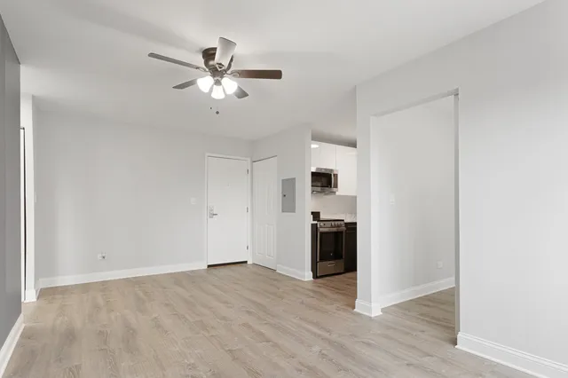 a view of a kitchen with a sink a ceiling fan and stainless steel appliances