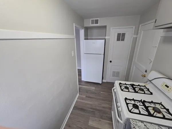a view of a utility room with a stove and a refrigerator