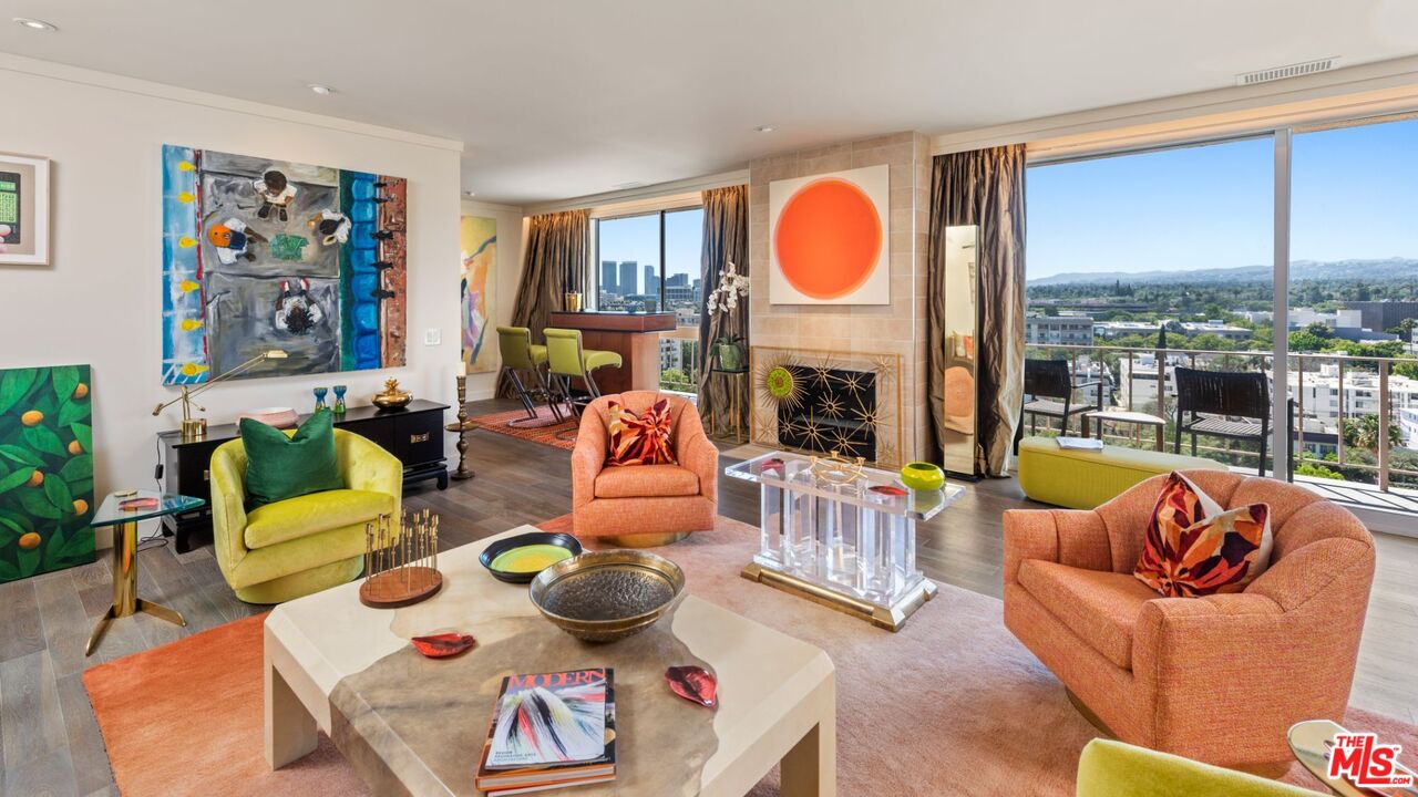 a living room with furniture fireplace and a large window