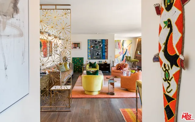 a living room with furniture and a painting on the wall